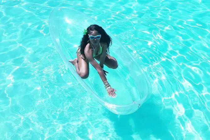 A guest posing on a transparent kayak photographed from above